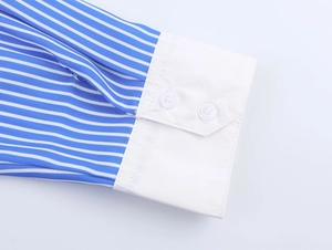 Close-up of blue and white striped shirt sleeve with white cuffs and double buttons