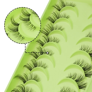 Close-up of 10 pairs natural false eyelashes in a light green tray with macro detail