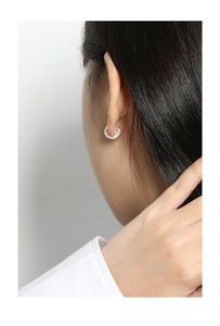 Close-up of minimalist S925 sterling silver hoop earring with sparkling zircon inlays
