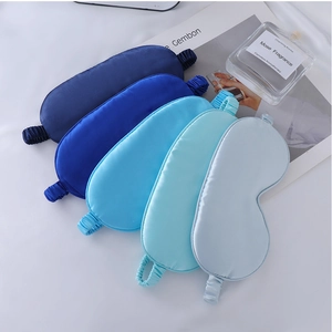 Set of 5 satin sleep masks in blue gradient shades displayed with home decor