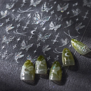 Holographic butterfly nail art stickers with metallic stars and moon designs for DIY manicure