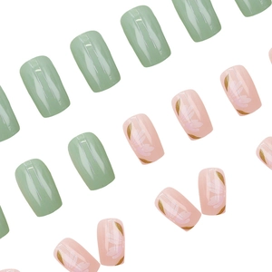 Green and pink press-on nails with white floral patterns and gold leaves in square shape