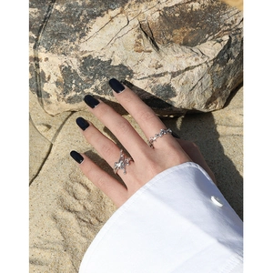 Minimalist S925 sterling silver open rings with fluid texture worn on a beach background