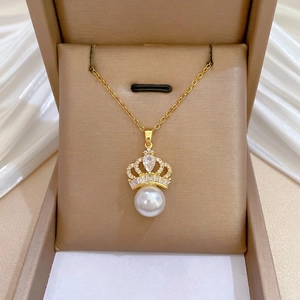 Elegant gold titanium crown necklace set with full diamonds and a white pearl drop