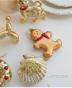 Detailed close-up of festive gold and red Christmas ornaments including dogs and gingerbread man