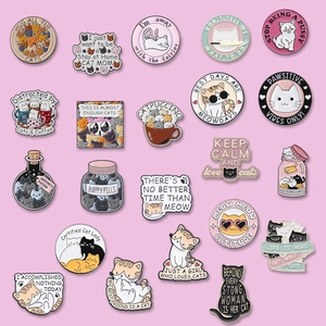 Detailed grid display of cute enamel cat pins with various colors and creative slogans