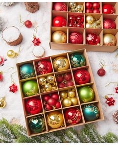 Detail of red and green Christmas ball ornaments in a kraft paper divider box