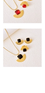 Detail view of vintage fan-shaped jewelry set with rectangular gemstones and gold plating