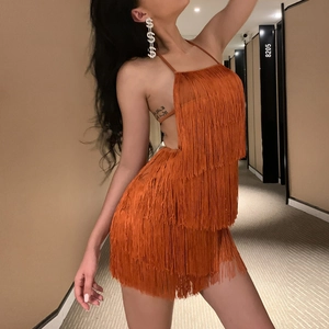 Detailed view of the layered orange fringe mini dress featuring a halter neck and open back