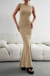 Macro shot of the khaki textured fabric and fishtail hem on the sleeveless long dress