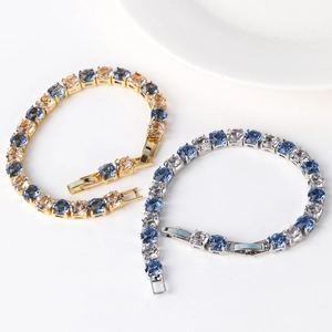 Detail view of gold and silver tennis bracelets with multicolor 6mm zircon stones