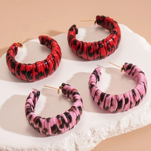 Leopard print leather hoop earrings in red and pink colors with geometric C-shape design