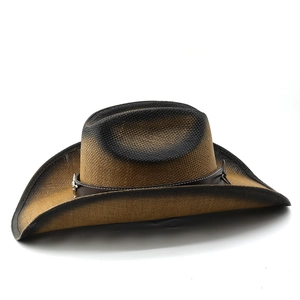 Close-up of woven straw cowboy hat with leather band and silver star emblem