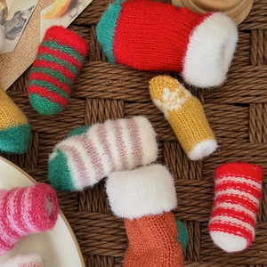 Miniature knitted Christmas socks collection for holiday decor and festive gift accessories