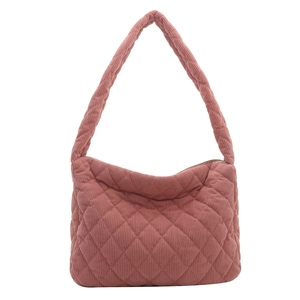 Pink corduroy tote bag with diamond quilting and wide shoulder strap on white background