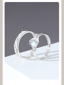 Detail of 925 sterling silver whale tail rings with glowing moonstone and wave pattern