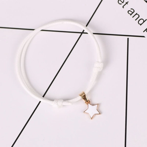 Minimalist white wax cord bracelet with a gold star pendant and adjustable knots