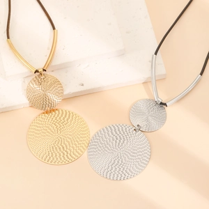 Exaggerated geometric double disc pendant necklace with spiral texture on rope chain