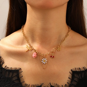 Gold-plated stainless steel chain necklace with daisy, dragonfly and cherry charms on model