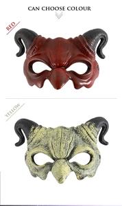 Detail view of red and yellow devil half-face masks with curved horns and muscle textures