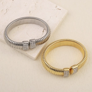 Detail of gold and silver Tubogas bracelets featuring sparkling rhinestone connectors