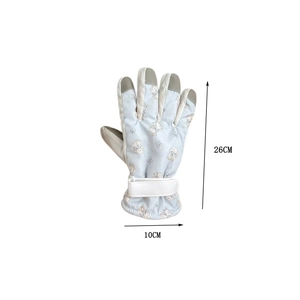 Detail showing touchscreen fingertips and adjustable velcro strap on blue ski gloves