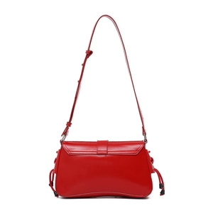 Close-up of vibrant red underarm bag featuring smooth texture and side drawstring details