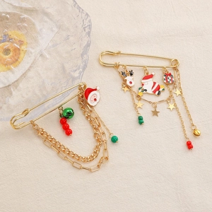Detailed view of Christmas safety pin brooches with Santa, deer and festive charms