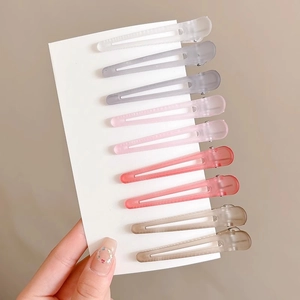 Set of 9 colorful matte hair clips on a card for volumizing and styling hair