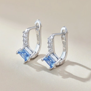 Macro shot of S925 sterling silver studs with blue square gemstones and S925 hallmark