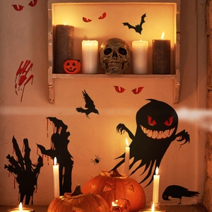 Halloween wall decals with bloody handprints, bats, and ghosts in a candlelit setting