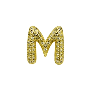 Detailed close-up of a 3D gold-plated letter M pendant with paved sparkling crystals