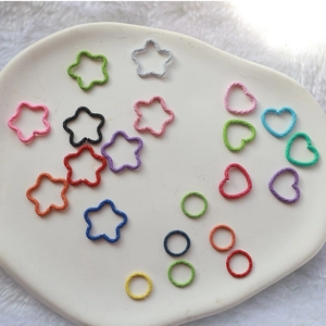 Colorful embossed jump rings in heart, star, and round shapes for DIY jewelry making