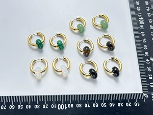 Detail of 18K gold stainless steel hoop earrings with various natural stone beads