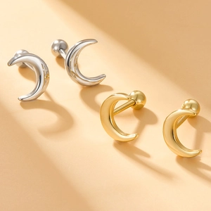 Macro detail of S925 silver moon screw back earrings in gold and silver finishes