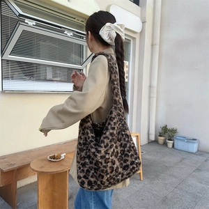 Outdoor street style shot showing the large leopard print faux fur tote bag worn on shoulder