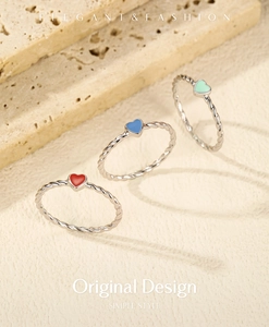 Detail of S925 silver twisted rings with colorful red blue and green enamel hearts