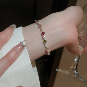 Close-up of multicolored zircon bracelet with teardrop stones on woman's wrist