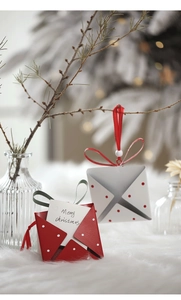Close-up of festive red and white envelope gift boxes with Merry Christmas cards
