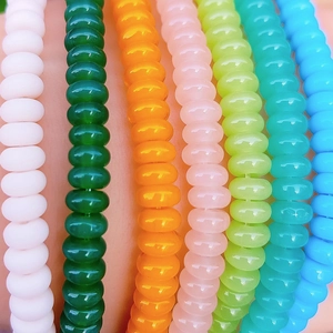 Macro shot of colorful flat round spacer beads in a vibrant vertical parallel display