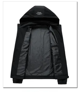Detail of hooded black windbreaker jacket featuring white text print on the hood top
