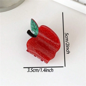 Sparkly red apple hair claw clip with green leaf detail, 5cm height, top view on white base