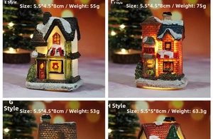 Detailed view of four lighted resin Christmas house ornaments with warm LED glow