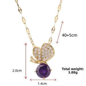 Detail shot of golden butterfly necklace with purple gemstone and size measurements