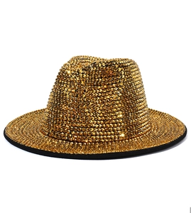 Close-up of sparkling gold rhinestones and black trim on a vintage jazz fedora hat