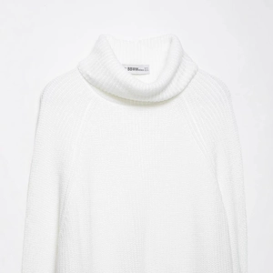 White high neck chunky knit sweater with split hem and soft oversized raglan sleeves