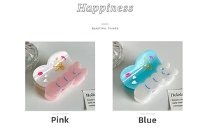 Close-up of cute bear-shaped hair claws in translucent pink and blue jelly texture