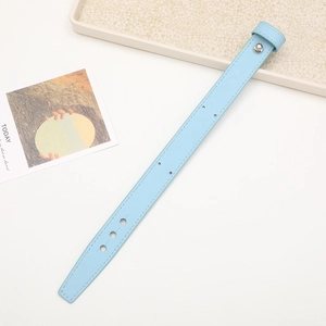 Detail of light blue leather wrist strap with adjustable holes and metal snap button
