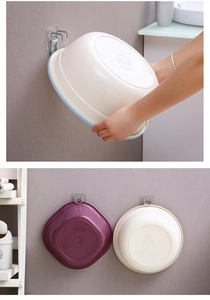 Detail of wall-mounted washbasin hooks showing damage-free adhesive and multi-basin storage