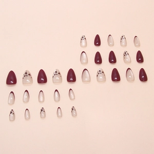 Burgundy and cream almond press-on nails with French tips and floral glitter accents